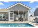View of the backyard with a in-ground pool and a screened-in porch at 1047 Harbison Circle, Myrtle Beach, SC 29579