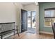 A well-lit foyer features wood floors, bench seating, and a front door that provides a view of the neighborhood at 1047 Harbison Circle, Myrtle Beach, SC 29579