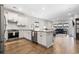 An open kitchen flows into the living room area, with white cabinets and stainless appliances at 1047 Harbison Circle, Myrtle Beach, SC 29579