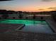 Backyard in-ground pool at dusk, with beautiful orange and purple sunset reflecting on the water at 1047 Harbison Circle, Myrtle Beach, SC 29579