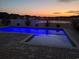 Beautiful in-ground pool illuminated at dusk, offering a serene and inviting ambiance at 1047 Harbison Circle, Myrtle Beach, SC 29579