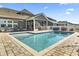 Backyard in-ground pool with brick patio, adjoined to the home's screened-in porch at 1047 Harbison Circle, Myrtle Beach, SC 29579