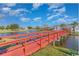 Scenic view of red bridge spanning a serene pond in a well-maintained community landscape at 1069 Williston Loop # 1069, Murrells Inlet, SC 29576