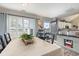 Dining area with large window featuring shutter blinds, neutral walls, and sleek hardwood floors at 1069 Williston Loop # 1069, Murrells Inlet, SC 29576