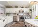 Charming kitchen features white cabinets, stainless steel appliances, and stylish backsplash at 1069 Williston Loop # 1069, Murrells Inlet, SC 29576