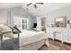 Comfortable bedroom features an ensuite bathroom, vaulted ceiling, and bright natural light at 1069 Williston Loop # 1069, Murrells Inlet, SC 29576