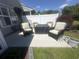 Inviting outdoor patio area, furnished with comfortable seating around a fire table, surrounded by beautiful landscaping at 1069 Williston Loop # 1069, Murrells Inlet, SC 29576