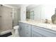 Contemporary bathroom features a tiled walk-in shower, double sinks, and gray vanity at 114-B 7Th Ave. N, Surfside Beach, SC 29575