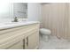 Bright bathroom featuring a modern vanity with white countertop and striped shower curtain at 114-B 7Th Ave. N, Surfside Beach, SC 29575