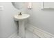 Small bathroom with a pedestal sink, modern fixtures and neutral wall color at 114-B 7Th Ave. N, Surfside Beach, SC 29575