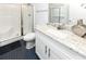 Bathroom featuring a walk-in shower with glass door, a white vanity with granite top, and blue tile floors at 114-B 7Th Ave. N, Surfside Beach, SC 29575