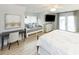 Bright bedroom with a cozy daybed, desk, TV, and balcony access at 114-B 7Th Ave. N, Surfside Beach, SC 29575