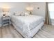 Cozy bedroom features stylish decor, a comfortable king bed with patterned bedding and plank flooring at 114-B 7Th Ave. N, Surfside Beach, SC 29575