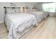 Inviting bedroom with three beds, soft gray bedding, and wood-look flooring at 114-B 7Th Ave. N, Surfside Beach, SC 29575