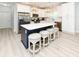 Modern kitchen with white cabinets, stainless appliances, a large island and stylish pendant lighting at 114-B 7Th Ave. N, Surfside Beach, SC 29575