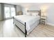 Spacious main bedroom featuring a king bed, balcony access and neutral decor at 114-B 7Th Ave. N, Surfside Beach, SC 29575