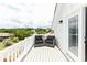 Outdoor seating with two chairs on a rooftop balcony overlooking the neighborhood at 114-B 7Th Ave. N, Surfside Beach, SC 29575