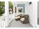 Comfortable outdoor seating with two wicker chairs with cushions and foot rests on a covered porch at 114-B 7Th Ave. N, Surfside Beach, SC 29575