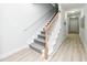 Bright staircase with carpeted stairs, and a light wood railing at 114-B 7Th Ave. N, Surfside Beach, SC 29575