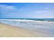 Calm ocean waves gently washing ashore on a sunny day in a serene beach scene at 1210 N Ocean Blvd. # 202, Surfside Beach, SC 29575