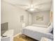 Cozy bedroom with twin beds, wood-look flooring, television, and light neutral walls at 1210 N Ocean Blvd. # 202, Surfside Beach, SC 29575