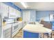 Bright kitchen featuring white appliances, countertops, and a breakfast bar at 1210 N Ocean Blvd. # 202, Surfside Beach, SC 29575