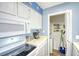 Kitchen featuring modern appliances and next to utility area with a washer and dryer at 1210 N Ocean Blvd. # 202, Surfside Beach, SC 29575