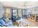 Living room features a blue couch, wood floors, and a view of the balcony at 1210 N Ocean Blvd. # 202, Surfside Beach, SC 29575