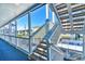 Outdoor staircase with wooden steps and white railings, offering views of surrounding homes at 1210 N Ocean Blvd. # 202, Surfside Beach, SC 29575