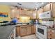 Bright kitchen with wooden cabinets, appliances, and sunny yellow walls at 1236 Pollen Loop, Murrells Inlet, SC 29576