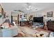 Cozy living room featuring rustic wood floors, a ceiling fan, and ample natural light at 1236 Pollen Loop, Murrells Inlet, SC 29576