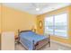 Bedroom with bright yellow walls, a ceiling fan and a large window for natural light at 124 Castaway Key Dr., Pawleys Island, SC 29585