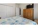 Bedroom with a wooden dresser and TV, featuring a double-door closet for storage at 1361 Midtown Village Dr., Conway, SC 29526