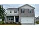 Charming two-story home features a two-car garage, neutral siding, and a well-maintained lawn at 149 Leyland Cypress Dr, Conway, SC 29527