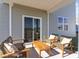 Covered patio area with comfortable seating, perfect for outdoor lounging and relaxation at 149 Leyland Cypress Dr, Conway, SC 29527