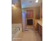 Warm Primary bathroom featuring a soaking tub, tile floors and traditional cabinetry at 153 Highmeadow Ln., Aynor, SC 29511