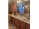 Bathroom with double sinks, wood cabinetry, and a large mirror at 153 Highmeadow Ln., Aynor, SC 29511