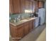 Well-lit kitchen featuring wood cabinets, modern appliances, and tile flooring at 153 Highmeadow Ln., Aynor, SC 29511