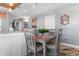 Open-concept dining area with wood floors and a wooden table set for four near the kitchen at 161 Seawatch Dr. # 1101, Myrtle Beach, SC 29572
