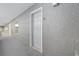 Exterior view of condo unit 1101's front door along a gray walled hallway with a concrete floor at 161 Seawatch Dr. # 1101, Myrtle Beach, SC 29572