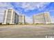 Beachfront condominium complex featuring multiple high-rise towers and stunning ocean views against a partly cloudy sky at 161 Seawatch Dr. # 1101, Myrtle Beach, SC 29572