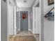 Hallway view with decor leading to a grey door and entrance with an area rug and light wood floors at 161 Seawatch Dr. # 1101, Myrtle Beach, SC 29572