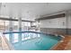 Bright indoor pool and spa area with tile flooring and large windows at 161 Seawatch Dr. # 1101, Myrtle Beach, SC 29572
