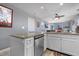 Bright, modern kitchen featuring granite counters, white cabinetry, stainless steel appliances, and wood-style flooring at 161 Seawatch Dr. # 1101, Myrtle Beach, SC 29572