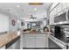 View of kitchen, island and living area featuring granite counters, stainless appliances and wood-style flooring at 161 Seawatch Dr. # 1101, Myrtle Beach, SC 29572