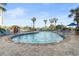 Community outdoor pool area with palm trees, lounge chairs, and blue skies at 161 Seawatch Dr. # 1101, Myrtle Beach, SC 29572