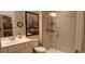 Bathroom featuring tile surround glass shower, white vanity, and decorative wall art at 1883 Suncrest Dr., Myrtle Beach, SC 29577