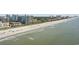 Expansive ocean and beach with condo buildings and a bright blue partly cloudy sky at 200 76Th Ave. N # 510, Myrtle Beach, SC 29572