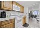 A well-equipped kitchen with oak cabinets, white appliances, and a view to the dining area at 200 76Th Ave. N # 510, Myrtle Beach, SC 29572