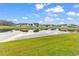 Picturesque backyard view with a tranquil pond reflecting a bright, cloudy sky and surrounding houses at 2020 Santa Maria St., Myrtle Beach, SC 29579